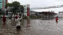 Warga bermain bola saat banjir merendam kawasan Green Garden, Jakarta Barat, Selasa (25/2/2020). Hujan yang mengguyur kawasan Jakarta membuat kawasan tersebut tergenang banjir setinggi 60-80 cm. (Liputan6.com/Johan Tallo)