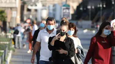 Orang-orang yang memakai masker terlihat di Via dei Fori Imperiali di Roma, Italia pada 6 Oktober 2020. Lima wilayah di Italia selatan memberlakukan peraturan wajib memakai masker, bahkan untuk orang-orang di ruang terbuka. (Xinhua/Cheng Tingting)