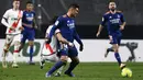 Gelandang Real Madrid, Casemiro (tengah) berebut bola dengan pemain Rayo Vallecano, Oscar Trejo pada pertandingan La Liga Spanyol di stadion Vallecas di Madrid, Spanyol, Minggu (27/2/2022). Real Madrid menang tipis atas Rayo Vallecano 1-0. (AP Photo/Jose Breton)