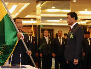 Ketua KONI Pusat, Tono Suratman (kiri) bersiap menyerahkan pataka PBSI kepada Ketua Umum PP PBSI Wiranto saat pelantikan di Jakarta, Kamis (19/1). Wiranto menjabat sebagai Ketua Umum PP PBSI periode 2016-2020. (Liputan6.com/Helmi Fithriansyah)