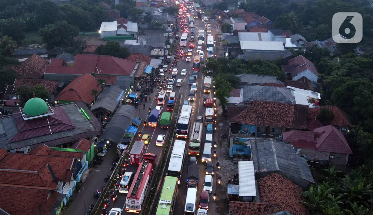 <p>Foto udara memperlihatkan kondisi lalu lintas di Simpang Jomin Pantura, Cikampek, Jawa Barat, Jumat (29/4/2022). Memasuki H-3 Idul Fitri, jalur mudik didominasi oleh kendaraan roda dua, truck dan mobil. (merdeka.com/Imam Buhori)</p>