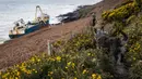 Kapal kargo sepanjang 77 meter, MV Alta,  terjebak di atas batu di dekat Ballycotton, Cork, Irlandia, Selasa (18/2/2020). "Kapal hantu" yang berlayar tanpa awak selama lebih dari satu tahun hanyut dan terbawa ke pantai selatan Irlandia menyusul sapuan Badai Dennis. (Cathal Noonan/AFP)