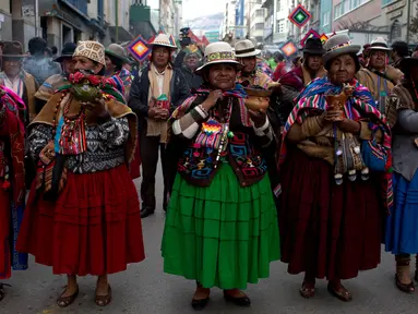 Pemimpin komunitas Andes membawa guci dengan dupa yang terbakar dalam sebuah arak-arakan patung dewa Ekeko di La Paz, Bolivia (23/1). Dewa Ekeko ini merupakan dewa kemakmuran di Bolivia. (AP Photo / Juan Karita)