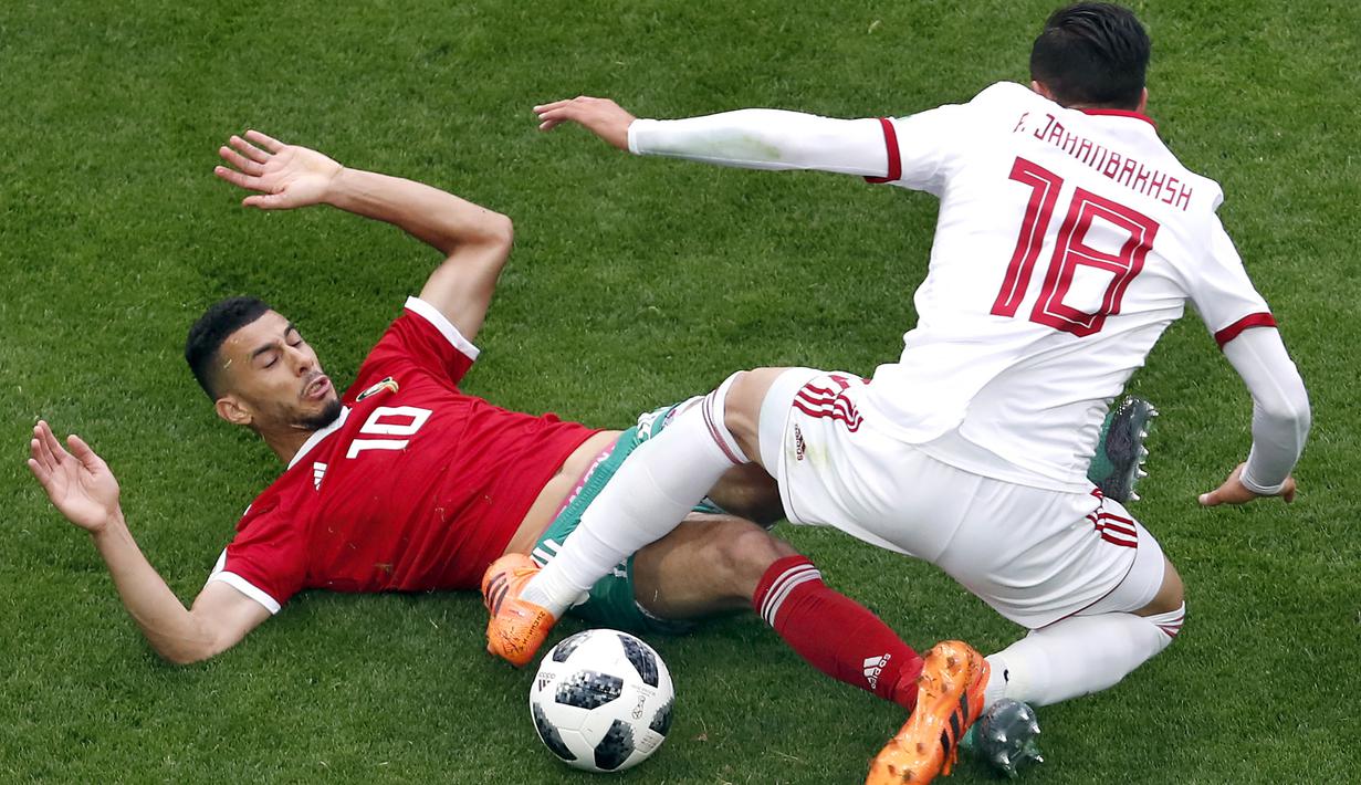 Aksi pemain Maroko, Younes Belhanda (kiri) saat berebut bola dengan pemain Iran, Alireza Jahanbakhsh pada  laga grup B Piala Dunia 2018  di St. Petersburg Stadium, Rusia, (15/6/2018). Iran menang 1-0. (AP/Darko Vojinovic)