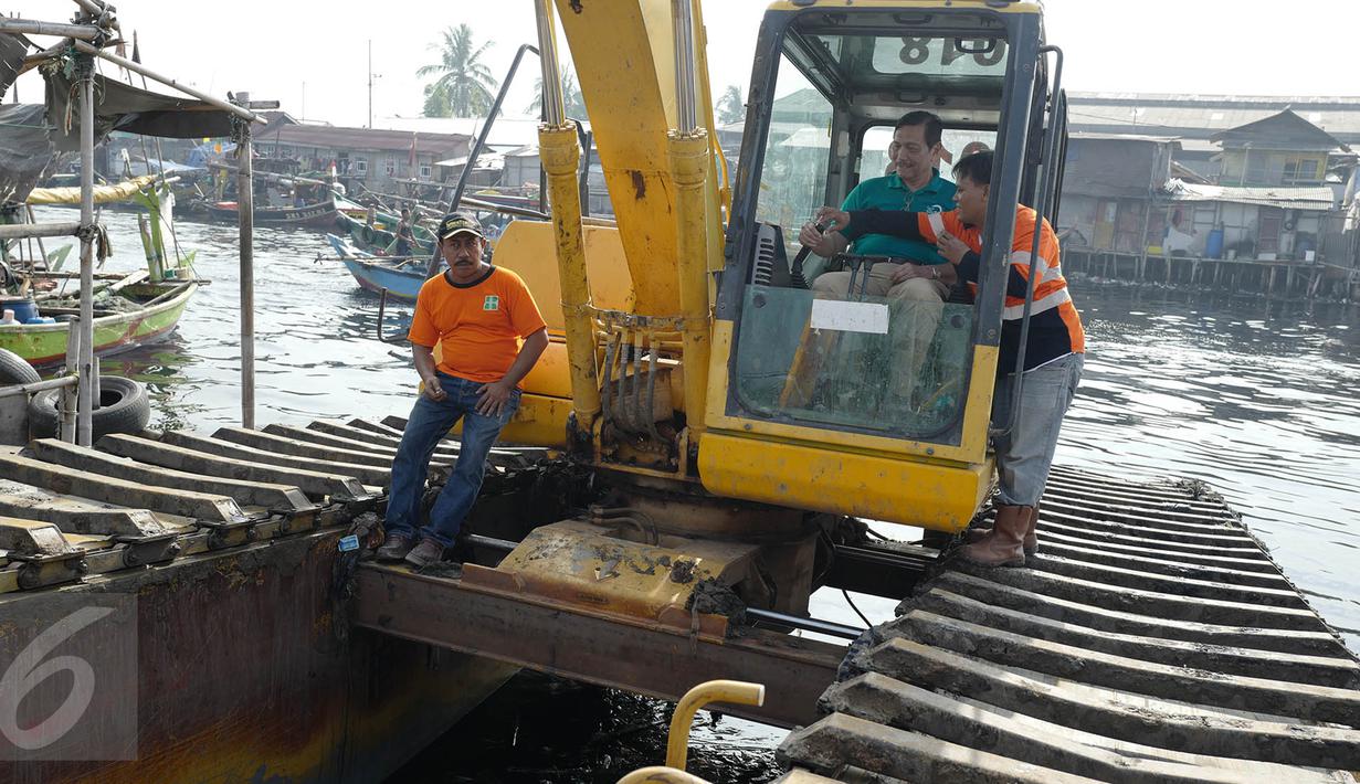 Menteri Koordinator Bidang Kemaritiman Luhut Binsar Panjaitan menaiki traktor menggelar gerakan aksi bersih di kawasan pesisir Cilincing, Jakarta Utara, Sabtu (6/4). Acara itu dalam rangka memperingati Hari Bumi. (Liputan6.com/Immanuel Antonius)