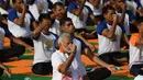 Perdana Menteri India, Narendra Modi memimpin pelaksanaan yoga massal pada Hari Yoga Internasional di Dehradun, Kamis (21/6). Modi adalah tokoh utama yang berhasil melobi PBB untuk menyatakan 21 Juni sebagai Hari Yoga Internasional. (AFP/PRAKASH SINGH)