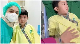 Lengkap pakai masker, nurse cap dan jubah khusus, Nycta Gina diketahui mendampingi Uta di ruang operasi. Baru berusia 7 tahun namun sudah merasakan menjalani operasi, wajah tegang terlihat di wajah Uta. Namun Gina dengan sabar menenangkan anak tercintanya itu. Lewat keterangan unggahannya, artis berusia 39 tahun ungkap bangga dengan anak pertamanya. (Liputan6.com/IG/@missnyctagina)