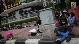 Sejumlah Mahasiswa IKJ Fakultas Seni Rupa duduk dipinggir jalan melukis suasana Bundaran HI, Jakarta Pusat, Kamis (19/10). Mereka melukis Bundaran Hotel Indonesia, Jakarta, dari berbagai sudut. (Liputan6.com/Faizal Fanani)