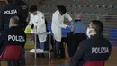 Petugas kepolisian Italia mendapatkan suntikan vaksin COVID-19 di pusat vaksinasi yang terletak di gym barak polisi di Roma, Jumat (10/12/2021). Pemerintah Italia telah mewajibkan vaksinasi COVID-19 bagi anggota polisi mulai 15 Desember mendatang. (AP Photo/Alessandra Tarantino)